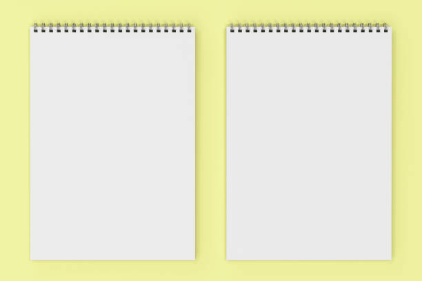 istock Blank white notebook with metal spiral bound on yellow background 827837060