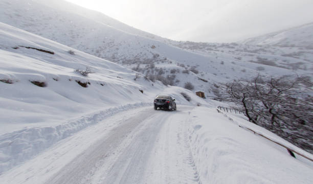 istock road with a car in winter in the mountains 827837576
