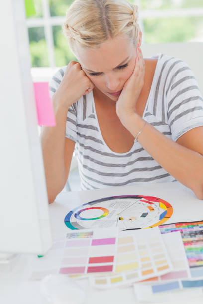 istock Thoughtful interior designer looking at a colour wheel 827837630