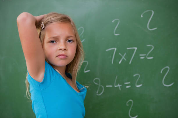 istock Schoolgirl thinking while scratching the back of her head 827840220