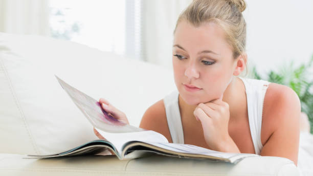 istock Woman reading a magazine 827843010