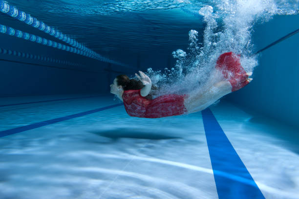 istock Swimmer in the dress dives underwater. 827847574