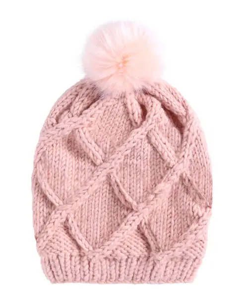 Pale pink winter knitted cap hat with a pom-pom isolated white