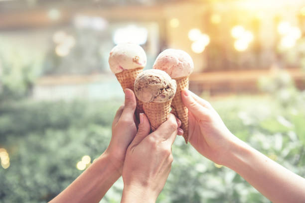 manos de mujer joven con conos de helado en verano - ice cream cone fotografías e imágenes de stock