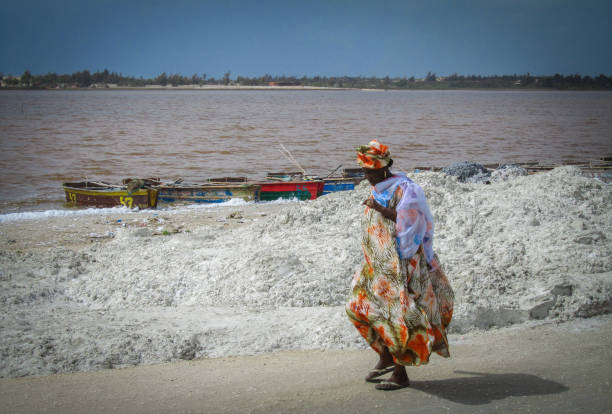 Dakar, Senegal - May 28, 2011 - A woman walks the shore of Lac Retba, also known as the pink lake