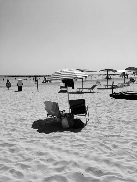 istock Beach life - beach umbrella - Summer life - Black and white (Pesaro, Italy) 827858312
