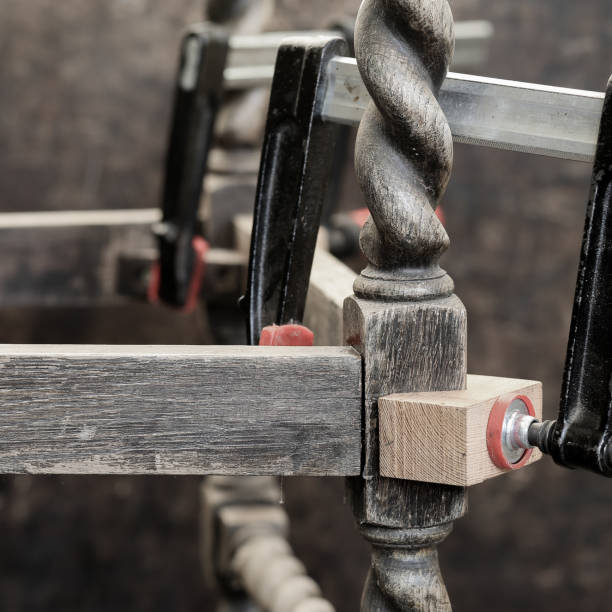 Old antique oak chair repair with wood glue and clamps - fotografia de stock