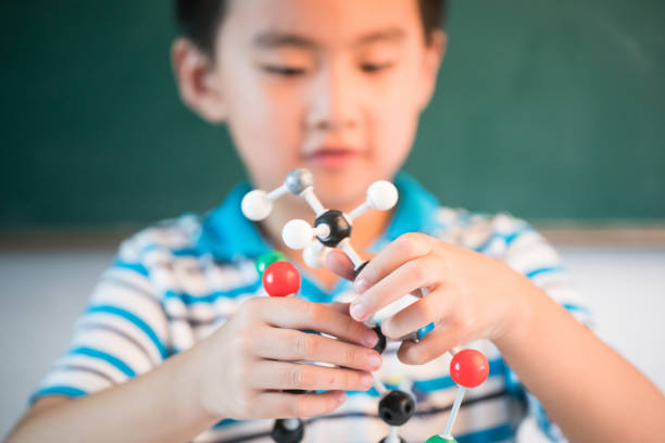 istock one asian boy playing ball and stick structure in the classroom 827870926