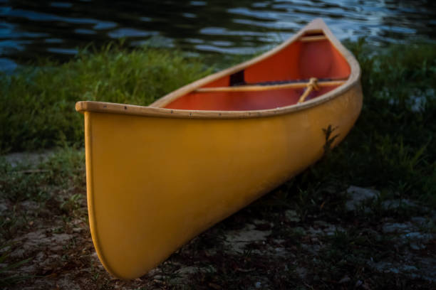 istock Yellow Canoe stranded on river bank at dusk 827871112