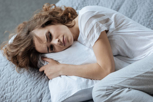 istock Cheerless young woman resting on the pillow 827871482