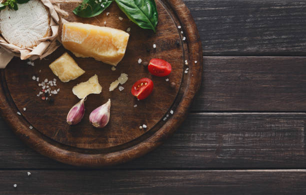 istock Cheese delikatessen closeup on rustic wood, brie and parmesan 827872018
