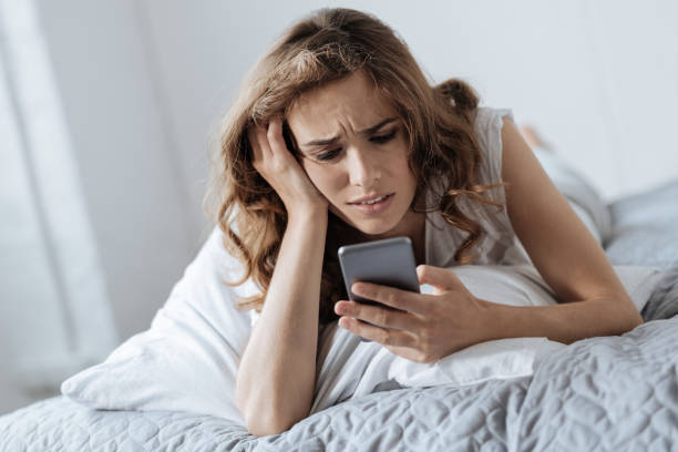 istock Cheerless attractive woman typing a message 827872350
