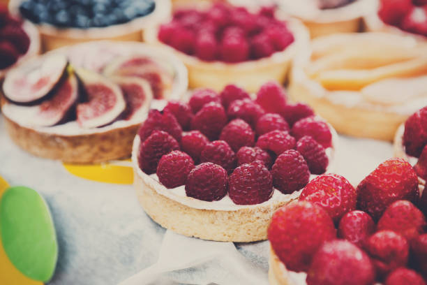 Fruit and berry tarts dessert tray assorted outdoors