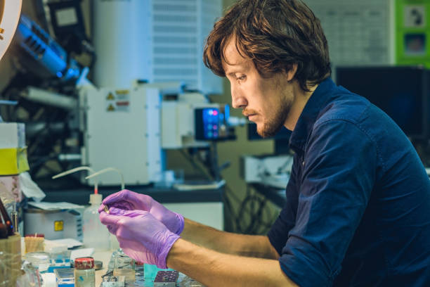 istock Scientist in a laboratory prepare a sample for an elecron microscopic investigation 827875318