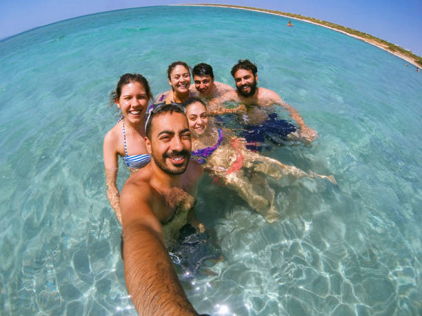 istock Group of multiracial happy friends taking fun selfie 827878770