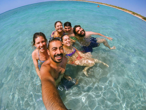istock Group of multiracial happy friends taking fun selfie 827878794