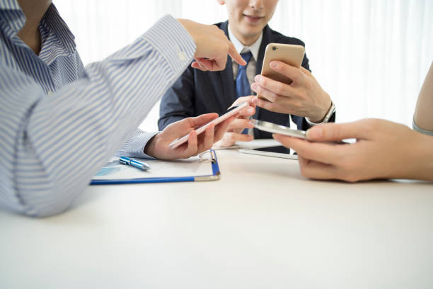 istock Three participants in the conference are using smartphones. 827879224