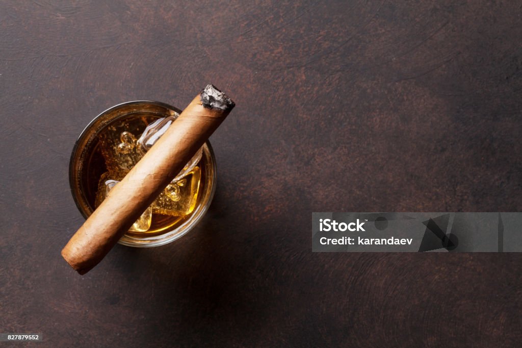Whiskey with ice and cigar Whiskey with ice and cigar. Top view with copy space Cigar Stock Photo
