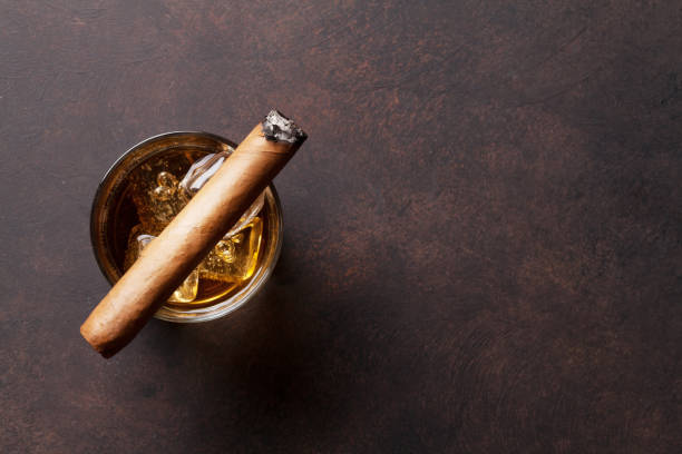 Whiskey with ice and cigar Whiskey with ice and cigar. Top view with copy space cigar photos stock pictures, royalty-free photos & images
