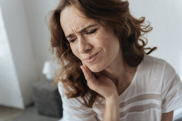 istock Upset young woman having a toothache 827880480
