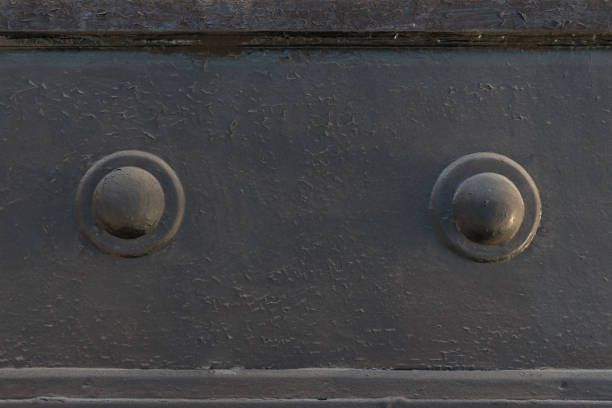 Metallic painted textured surface with large rivets