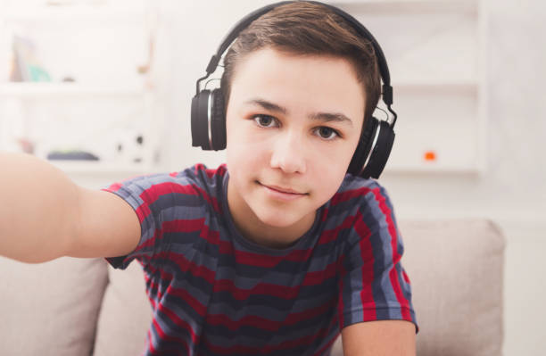 istock Boy in headphones taking selfie 827884400