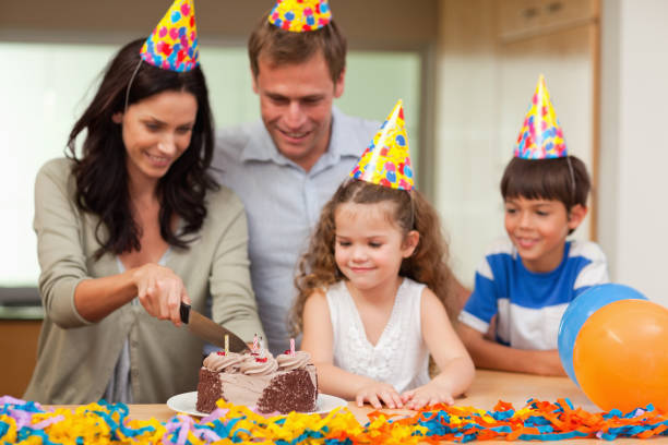 istock Mother cutting birthday cake 827884888