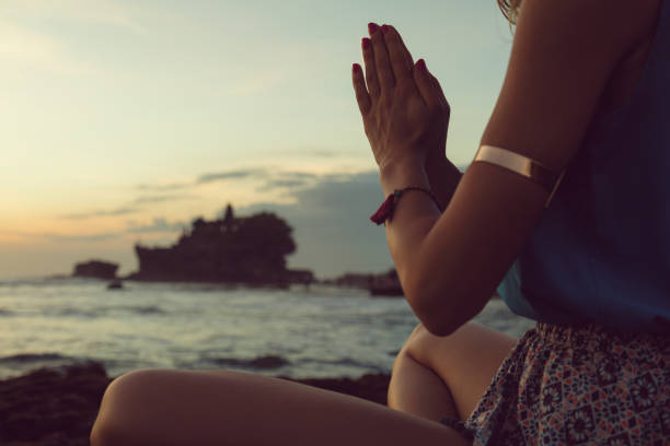 istock Young woman practicing yoga on the beach. 827887896
