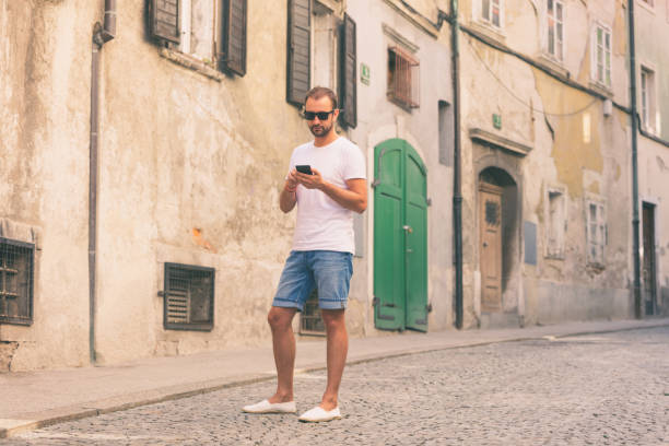 istock Modern guy using cellphone in the European city. 827890916