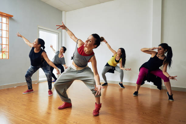 Hip-Hop Dancers Having Training Group of energetic hip-hop dancers focused on training while gathered together in spacious dance hall dancer stock pictures, royalty-free photos & images