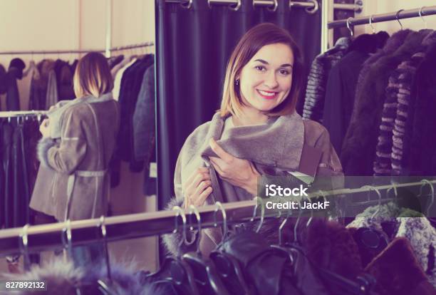 Girl Choosing Sheepskin Coat Stock Photo - Download Image Now - Adult, Adults Only, Choice