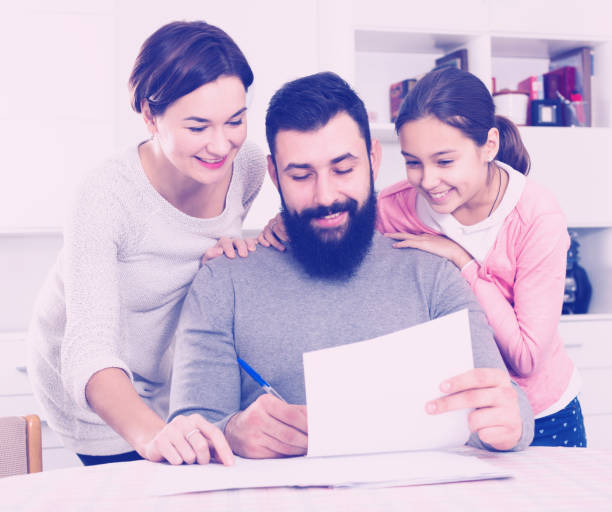 istock Parents signing property papers 827892222