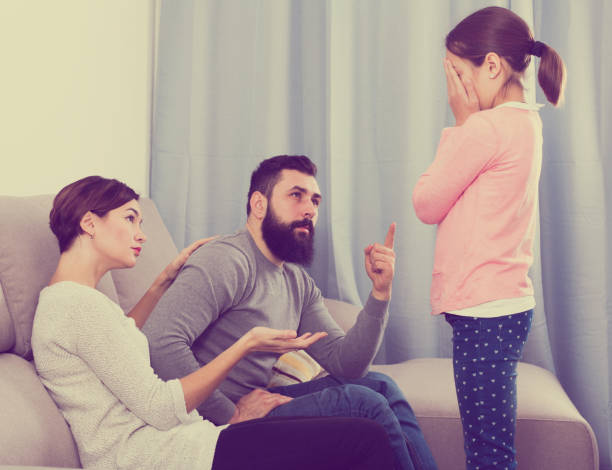 istock Father and mother correcting their child 827892232