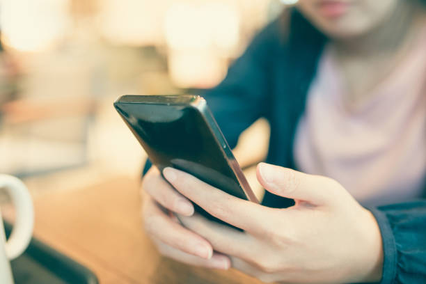 istock Woman hand holding phone 827896494