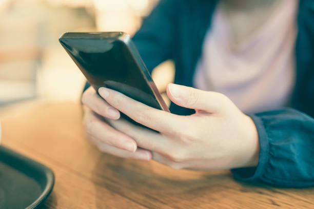 istock Woman hand holding phone 827896924