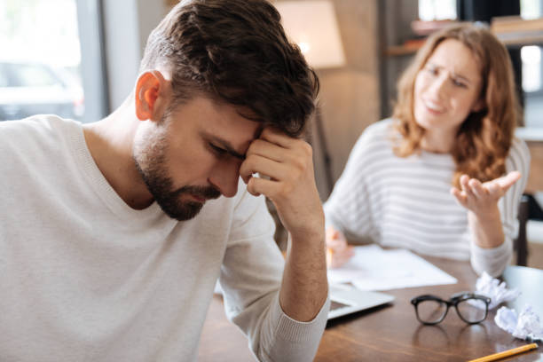 Thoughtful sad man holding his forehead stock photo