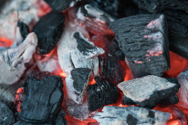 istock Hot charcoal briquettes background texture 827897320