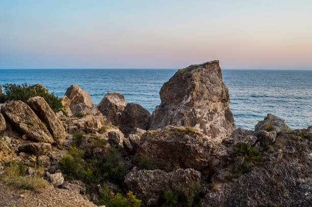 istock Sea and rocks at sunset 827897470