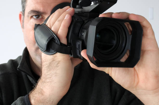 istock Cameraman shooting footage with video camera 827897788