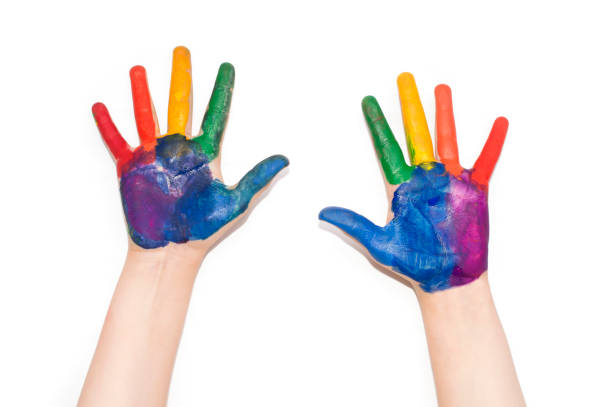 istock Children's hands painted with colorful paint. 827900686