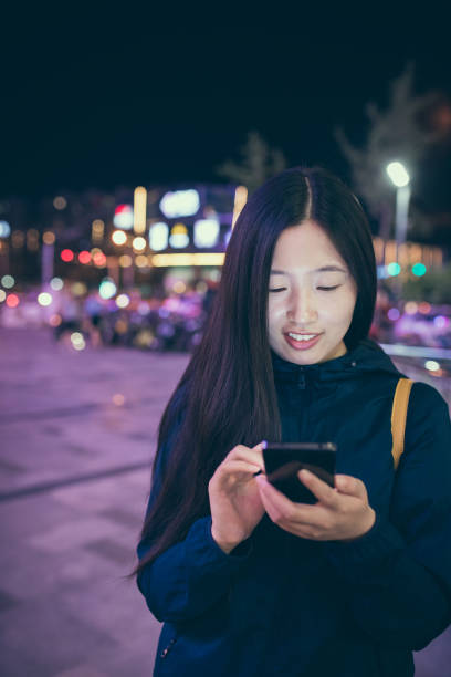 istock Young woman using phone at night 827901124