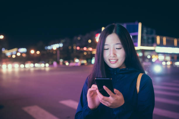 istock Young woman using phone at night 827901130