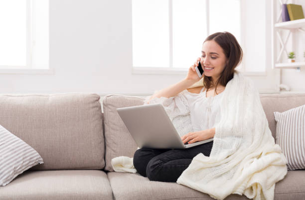 istock Girl in a plaid with a laptop and mobile 827904052
