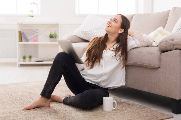 istock Girl with a tablet at home 827904182