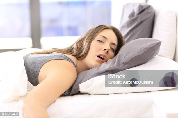 Tired Woman Resting On A Bed At Home Stock Photo - Download Image Now - Sleeping, Women, Bed - Furniture