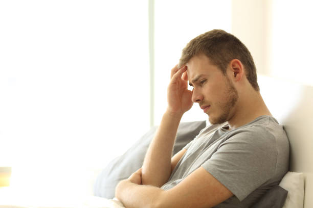 istock Sad man lamenting on the bed 827904614