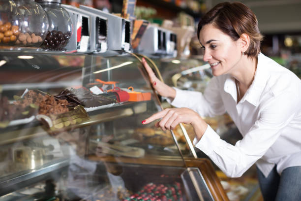 istock Female client choosing delicious dessert 827904874