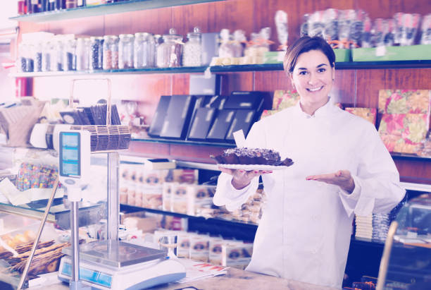 istock Glad seller offering festive chocolate cake 827904878