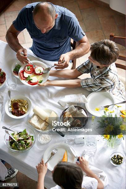 Family Having Typcaly Italian Meal Stock Photo - Download Image Now - Family, Mozzarella, Eating