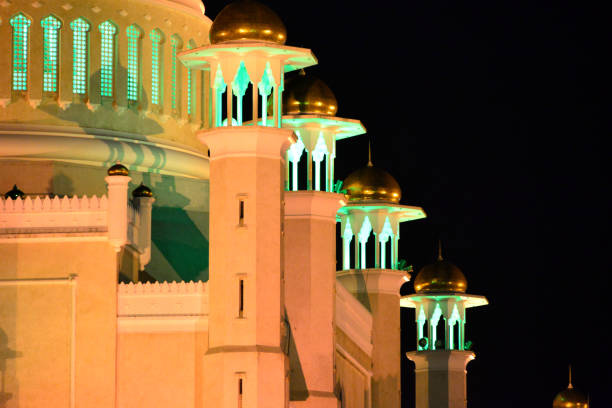 Bandar Seri Begawan, Brunei Darussalam: Sultan Omar Ali Saifuddin mosque - nocturnal detail - drum of the dome and secondary minarets with golden 'hats' - photo by M.Torres